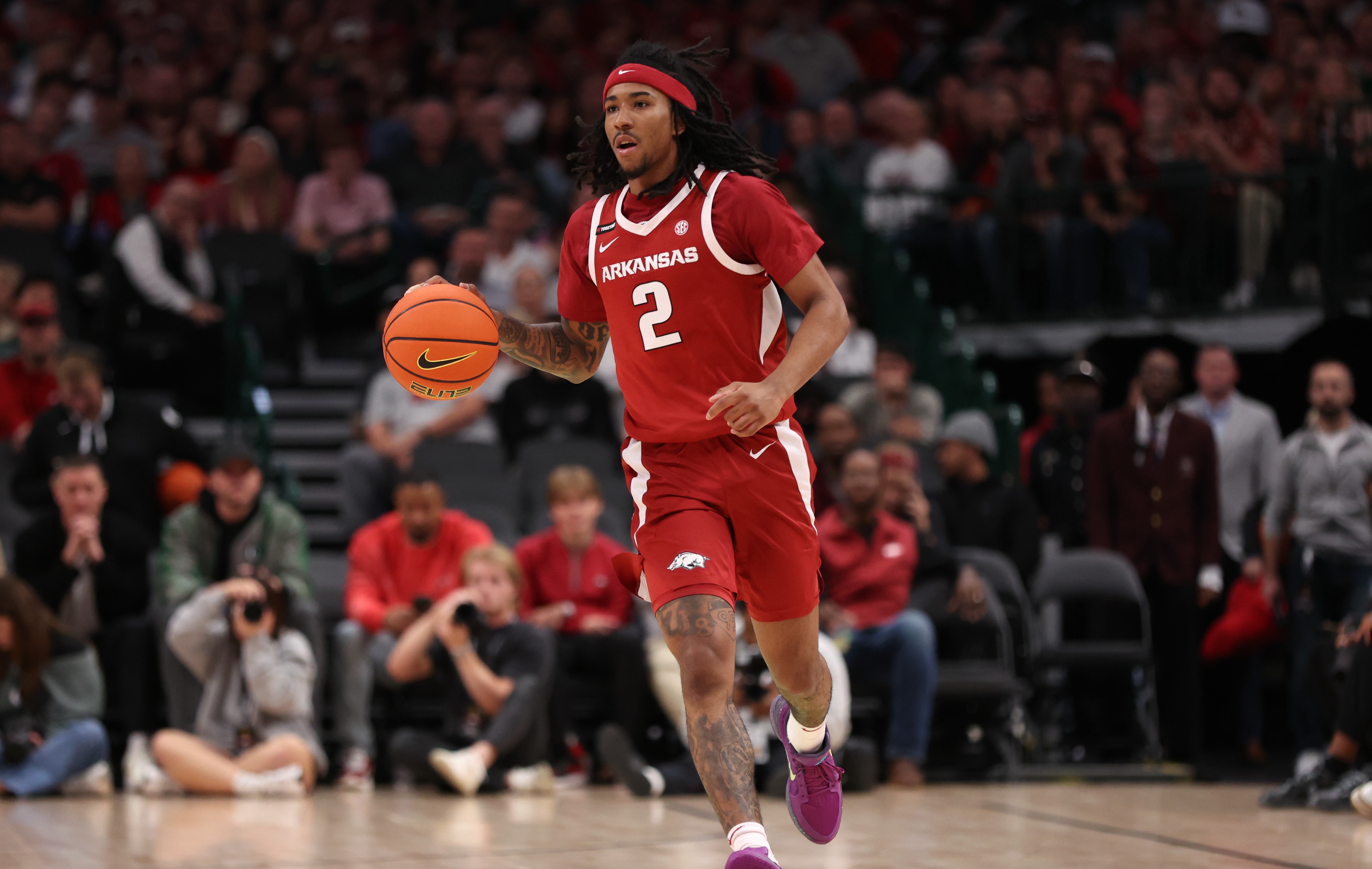 Boogie Fland #2 of the Arkansas Razorbacks brings the ball up court during the first half against the Baylor Bears at American Airlines Center on November 09, 2024 in Dallas, Texas.