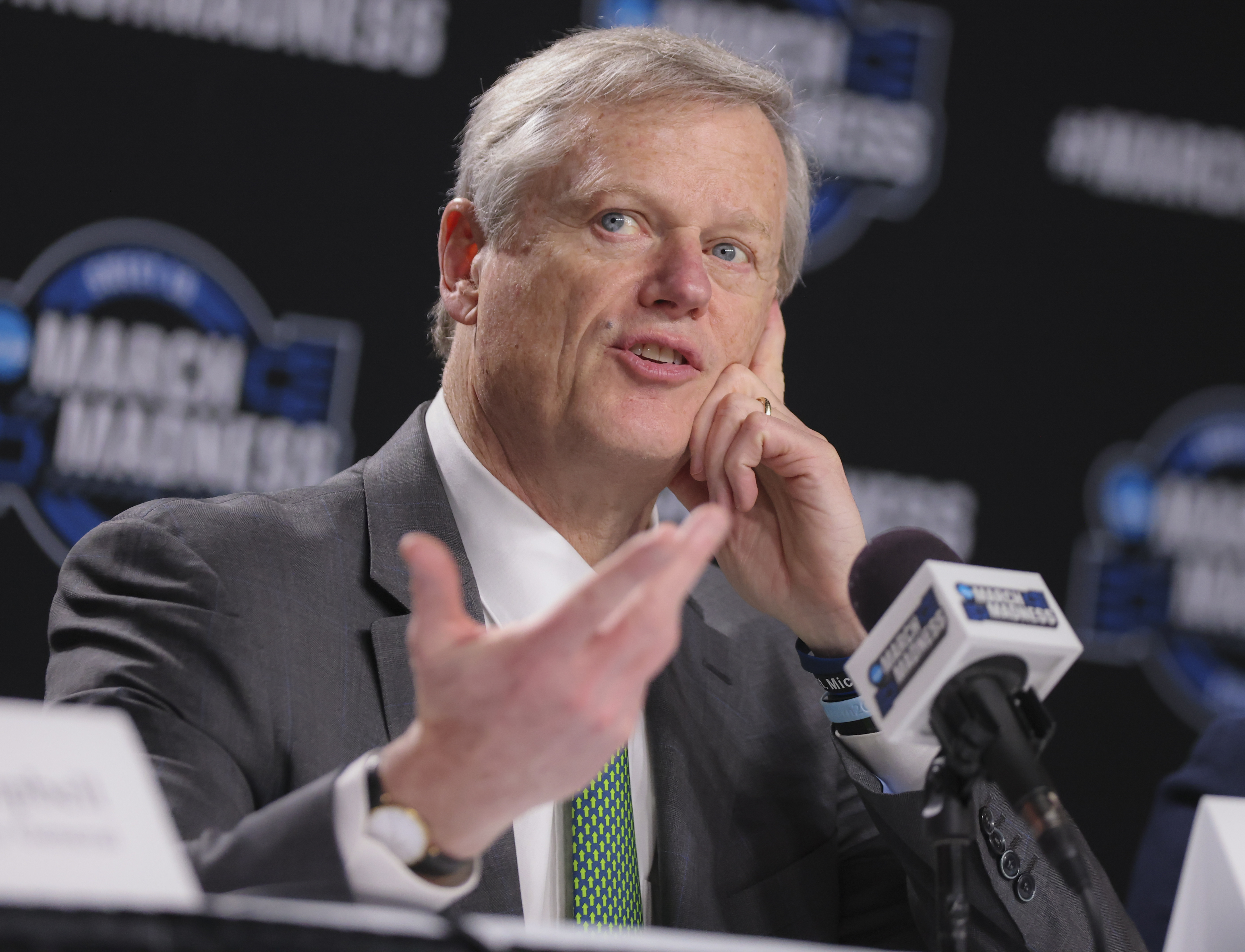 NCAA President Charlie Backer answers questions in front of a microphone during the 2024 NCAA Tournament