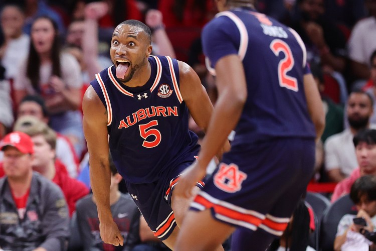 Auburn basketball players celebrating their win over the University of Houston