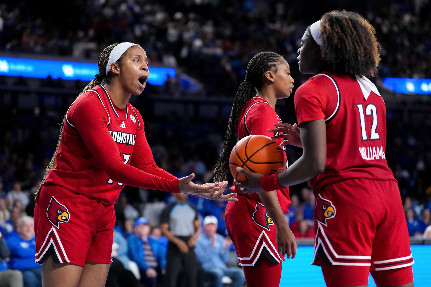 Merissah Russell #13 and Ja'Leah Williams #12 of the Louisville Cardinals react in overtime