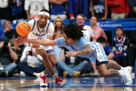 Dajuan Harris Jr. #3 of the Kansas Jayhawks and Elliot Cadeau #3 of the North Carolina Tar Heels battle for a loose ball during the first half of the game at Allen Fieldhouse on November 08, 2024 in Lawrence, Kansas.