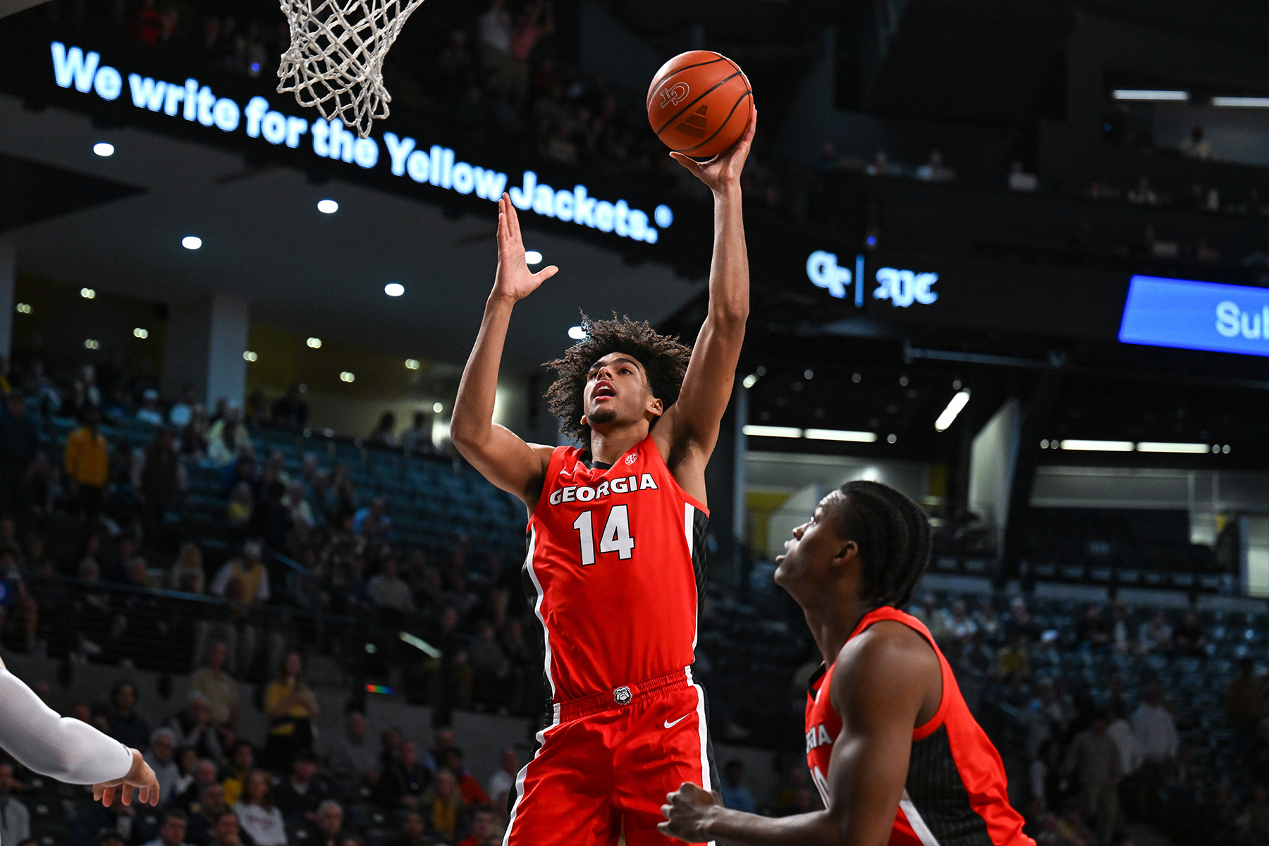 Asa Newell holds the ball up in his left hand about to take short shot during a game.