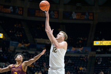 Tucker DeVries #12 of the West Virginia Mountaineers takes a shot during an exhibition college basketball game against the Charleston Golden Eagles at WVU Coliseum on October 18, 2024