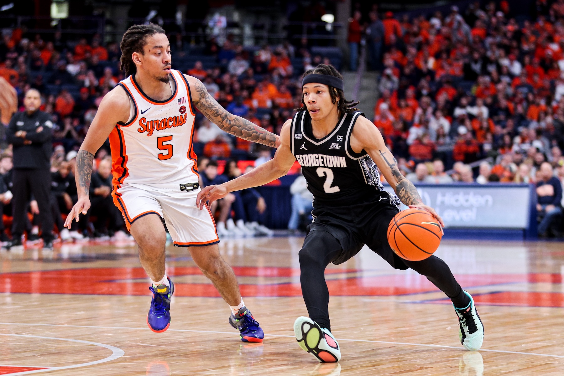 Jaquan Carlos #5 of the Syracuse Orange guards Malik Mack #2