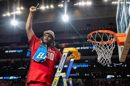 DJ Burns Jr. of NC State cuts down the nets after an Elite 8 win in the 2024 NCAA Tournament