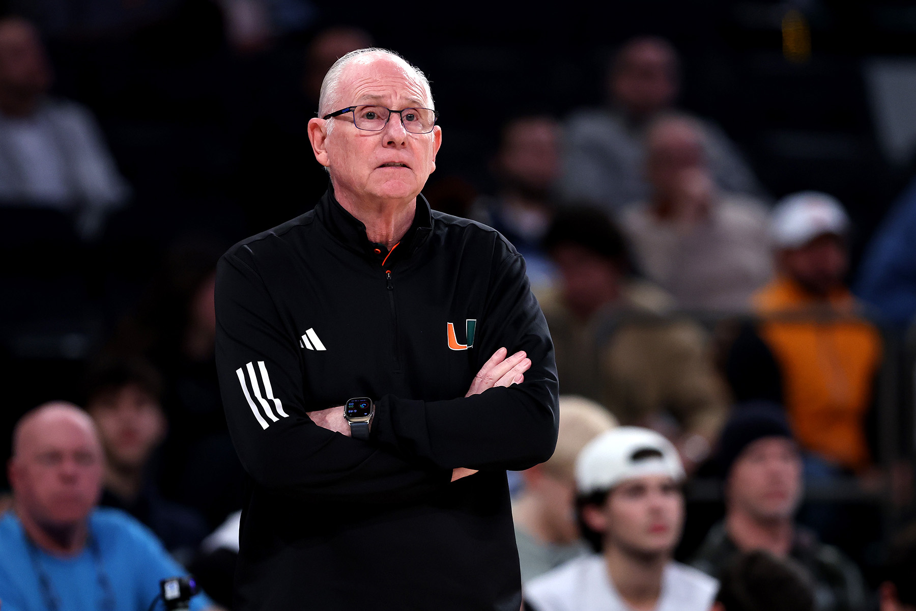 Miami coach Jim Larranaga stands on the sidelines with his arms folded.