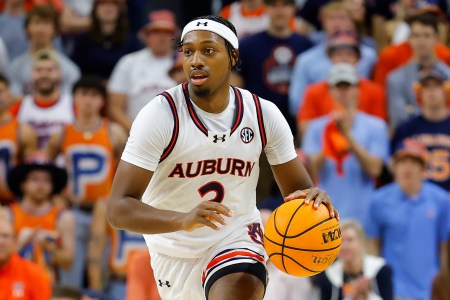 Auburn basketball player Denver Jones dribbles up the court