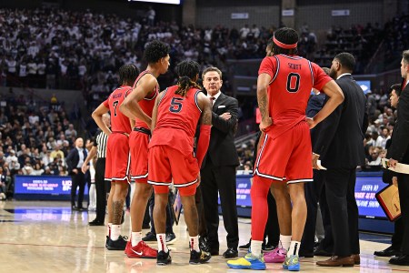 St. John's head coach Rick Pitino huddles with his team during a game.