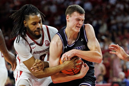 Jacob Ognacevic #41 of the Lipscomb Bison drives to the basket against Jonas Aidoo #9 of the Arkansas Razorbacks