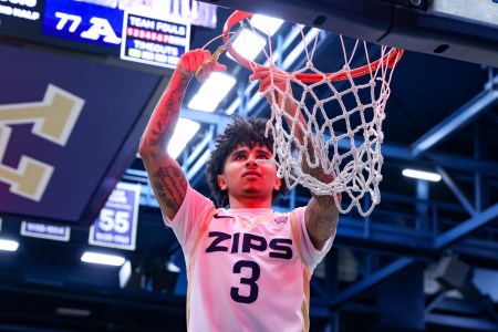 FEBRUARY 28: Akron Zips guard Sharron Young (3) cuts down the net after the Akron Zips clinching the Mid-American Conference regular season championship after defeating the Kent State Golden Flashes on February 28, 2025, at the James A. Rhodes Arena in Akron, OH.